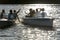 Silhouette of young friends in motorboats