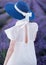 The silhouette of a young girl dressed in a white dress and looking at her side, which stands in the middle of blooming lavender