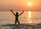 Silhouette of young girl jumping in sea