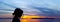 Silhouette of a young girl with sunset over the Adriatic Sea in background - Makarska