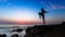 Silhouette of young gymnastics woman doing exercises on the Sea.