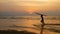 Silhouette of young happy surf man running with long surf boards at sunset on tropical beach. surfer on the beach in sea shore