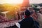 Silhouette of young male backpacker watching sunset and pagoda in Bagan, Burma.