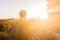 Silhouette of young male backpacker watching sunset and pagoda in Bagan, Burma.