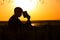 Silhouette of a young man with a Bible, male praying to God in nature, the concept of religion and spirituality