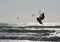 Silhouette of Young Man Kite Boarding in sea Waves