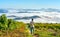 Silhouette young man standing on a high hill scenic rural hometown