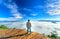 Silhouette young man standing on a high hill scenic rural hometown