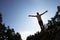 Silhouette Of Young Man Standing On Rock