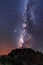 Silhouette of a young man under the stars looking at the lactea way