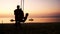 Silhouette of young mother swinging little children in beach swing at sunset beach. slow motion. 1920x1080