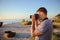 Silhouette of young photographer on the beach