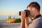 Silhouette of young photographer on the beach