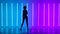 Silhouette of a young stylish girl dancing against the background of multicolored neon tubes. The dancer performs modern