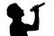 Silhouette of a young talented man singing into a microphon