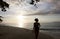 Silhouette of young woman on the beach at sunset