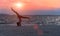 Silhouette young woman lifestyle exercising vital meditate and practicing yoga on the beach at sunset.