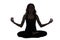 Silhouette of a young woman in meditation pose