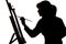 Silhouette of a young woman painting on an easel on a white isolated background, the figure of a girl with a brush and gamut, a