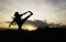 Silhouette of young woman practicing yoga outdoor. Female happiness. Sport and healthy concept