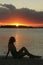 Silhouette of young woman at sunset, Boca Chica bay