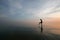 Silhouette of young woman wading in sea