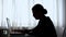 Silhouette of young woman working extra hours till early morning, workaholic