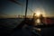 Silhouette of young women sitting on the edge of the sailboat