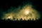 Silhouette of zombies walking over cemetery in night. Horror Halloween concept of group of zombies at night