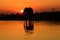 Silhouetted African elephant and shadow reflected in water