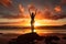 Silhouetted against a fiery sunrise, a person strikes a yoga pose on a beach rock, embodying the Empowerment concept