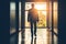 Silhouetted Businessman Approaching in a Sunlit Corridor