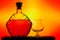 Silhouetted cognac glass and bottle on gradient background