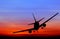 Silhouetted commercial airplane flying