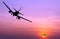 Silhouetted commercial airplane flying