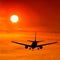 Silhouetted commercial airplane flying