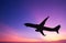 Silhouetted commercial airplane flying