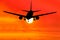 Silhouetted commercial airplane flying