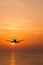 Silhouetted commercial airplane flying