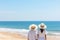 Silhouetted couple enjoying a picturesque beach day with sparkling waves in the background