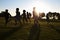 Silhouetted elementary school kids running in a field