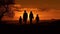 Silhouetted family finds happiness holding hands in the countryside sunset