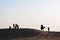 Silhouetted Family Group Couple on Camel desert landscape