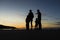 Silhouetted family outdoors looking at the sunset