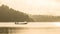 Silhouetted fisherman and boat with mountain background