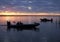 Silhouetted Fishermen Heading Out as the Sun Comes Up in a Beautiful Sunrise