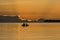 Silhouetted fishermen sitting on a boat