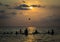 Silhouetted group of boy are playing a ball in the sea