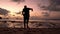 Silhouetted guy on the beach during sunset. Sunset in the tropics. The guy joyfully runs into the water