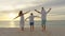 Silhouetted happy asian family playing and having fun on the beach at sunset. Family, freedom and travel concept.